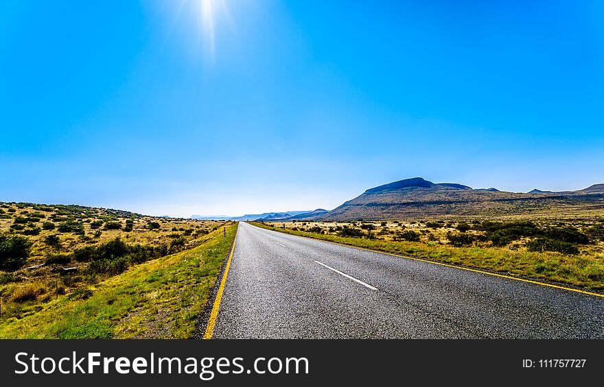 Long Straight Road Through The Endless Wide Open Landscape Of The Semi Desert Karoo Region In Free State And Eastern Cape Province