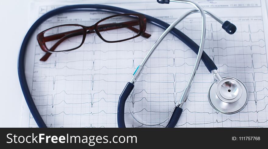 Stethoscope On Cardiogram Concept For Heart Care On The Desk.blue Toned Images