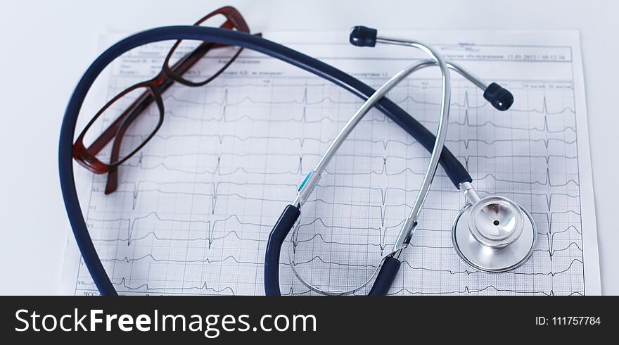 Stethoscope On Cardiogram Concept For Heart Care On The Desk.blue Toned Images