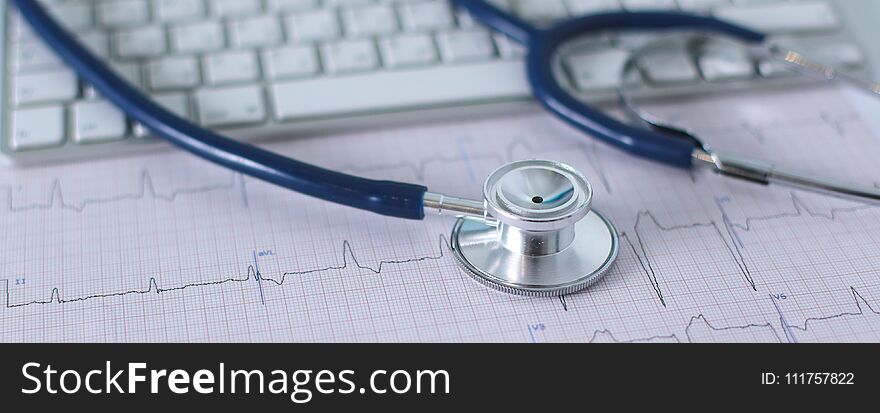 Stethoscope on cardiogram concept for heart care on the desk.blue toned images