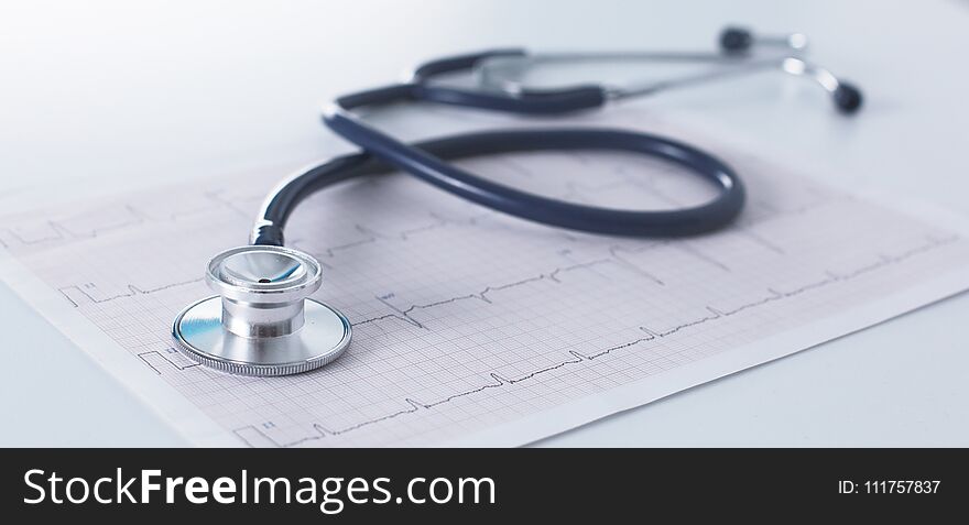 Stethoscope On Cardiogram Concept For Heart Care On The Desk.blue Toned Images
