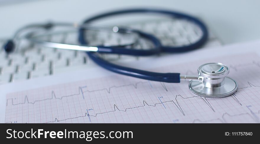 Stethoscope on cardiogram concept for heart care on the desk.blue toned images