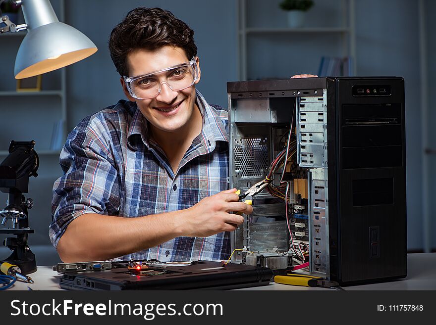 The man repairing computer desktop with pliers