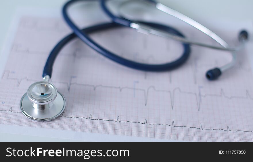 Stethoscope on cardiogram concept for heart care on the desk.blue toned images.