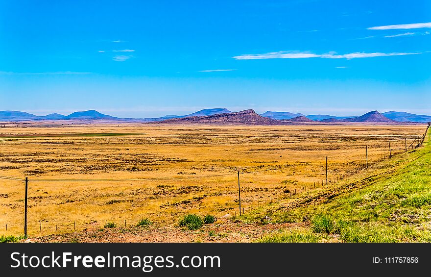 Endless wide open landscape of the semi desert Karoo Region in Free State and Eastern Cape provinces in South Africa under blue sky