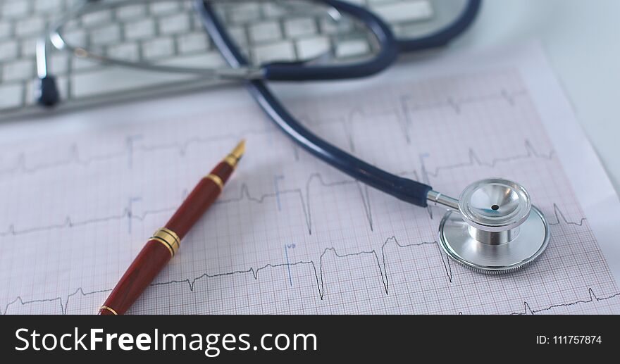 Stethoscope on cardiogram concept for heart care on the desk.blue toned images.