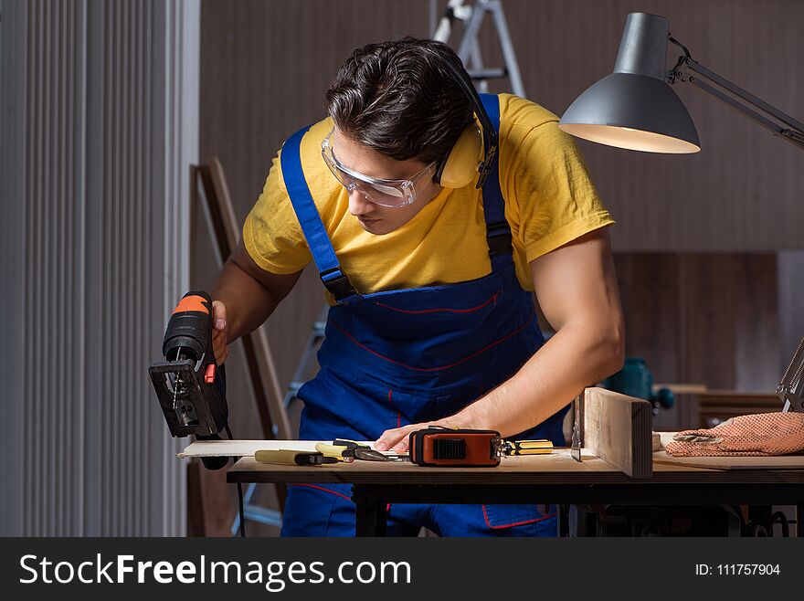 The Worker Working In Repair Workshop In Woodworking Concept