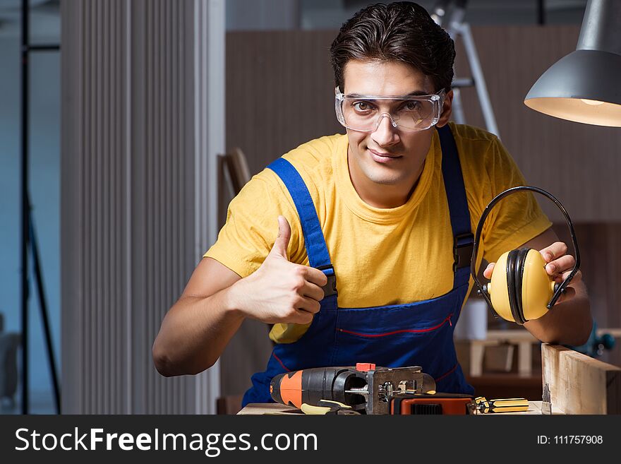 The Worker Working In Repair Workshop In Woodworking Concept