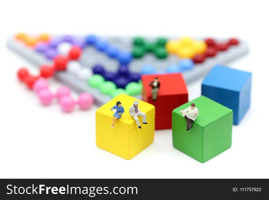 Miniature people : Businessman with Colorful abacus and kids toy,business and education concept.