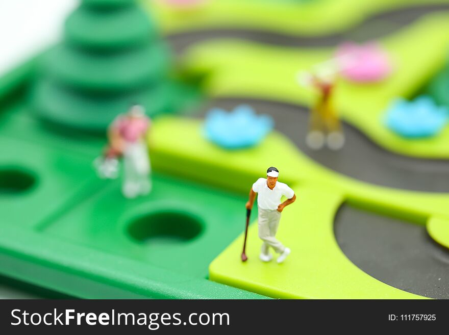 Miniature people : golfer stand with children`s toys collection