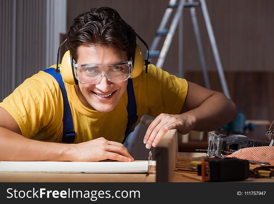 The worker working in repair workshop in woodworking concept