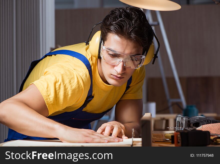 The worker working in repair workshop in woodworking concept