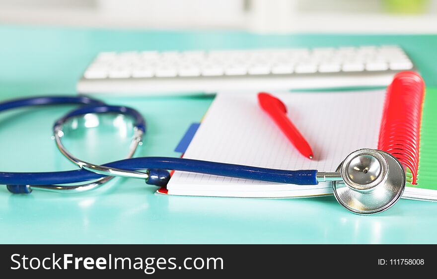 Doctor`s workspace working table with patient`s discharge blank paper form, medical prescription, stethoscope on desk