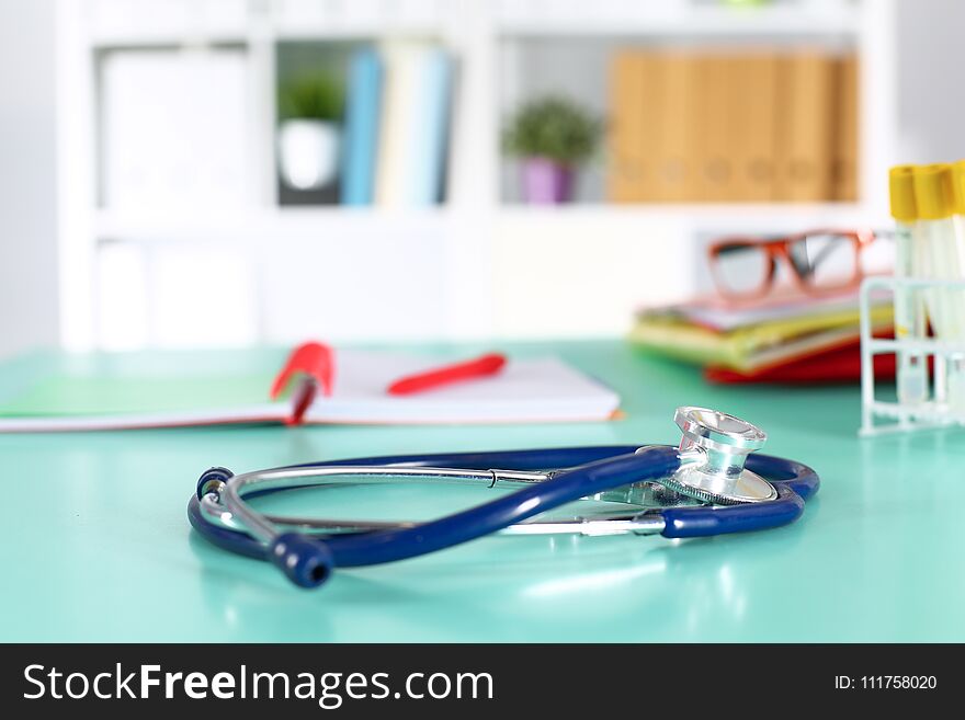 Doctor`s Workspace Working Table With Patient`s Discharge Blank Paper Form, Medical Prescription, Stethoscope On Desk