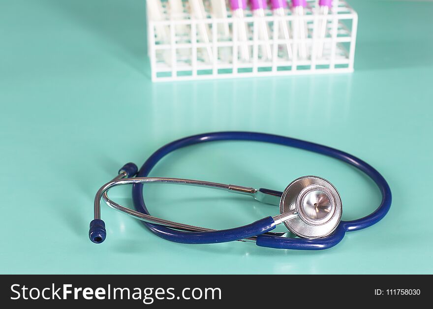 Doctor`s workspace working table with patient`s discharge blank paper form, medical prescription, stethoscope on desk.