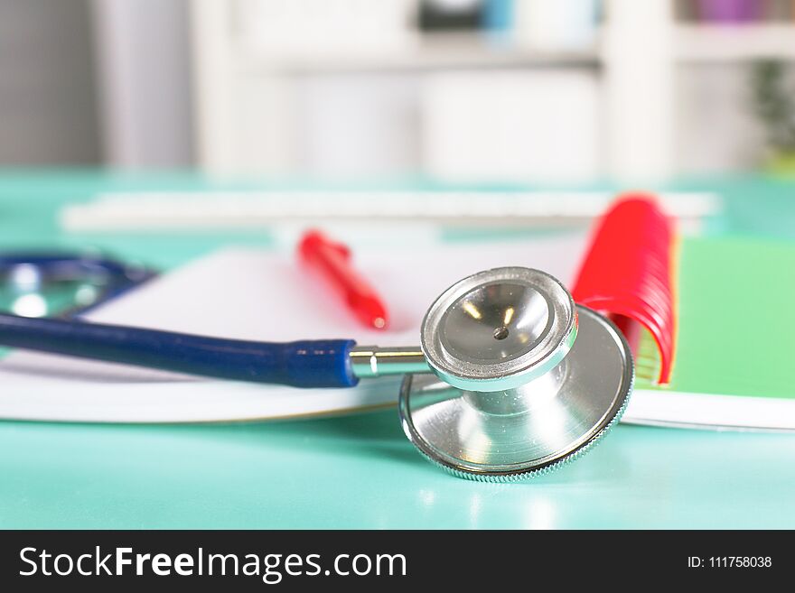 Doctor`s Workspace Working Table With Patient`s Discharge Blank Paper Form, Medical Prescription, Stethoscope On Desk