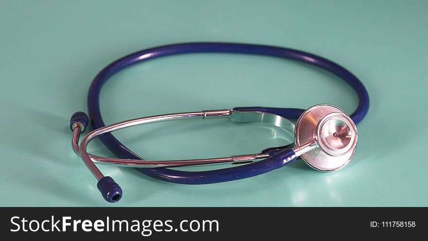 Medical Concept. Top view of stethoscope, clipboard, pen and eye glasses on blue background. Flat lay and copy space.
