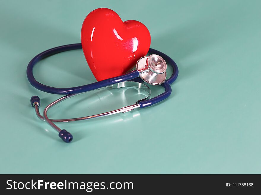 Red Heart With Stethoscope On Blue Wooden Background. Copy Space. Valentines Day.