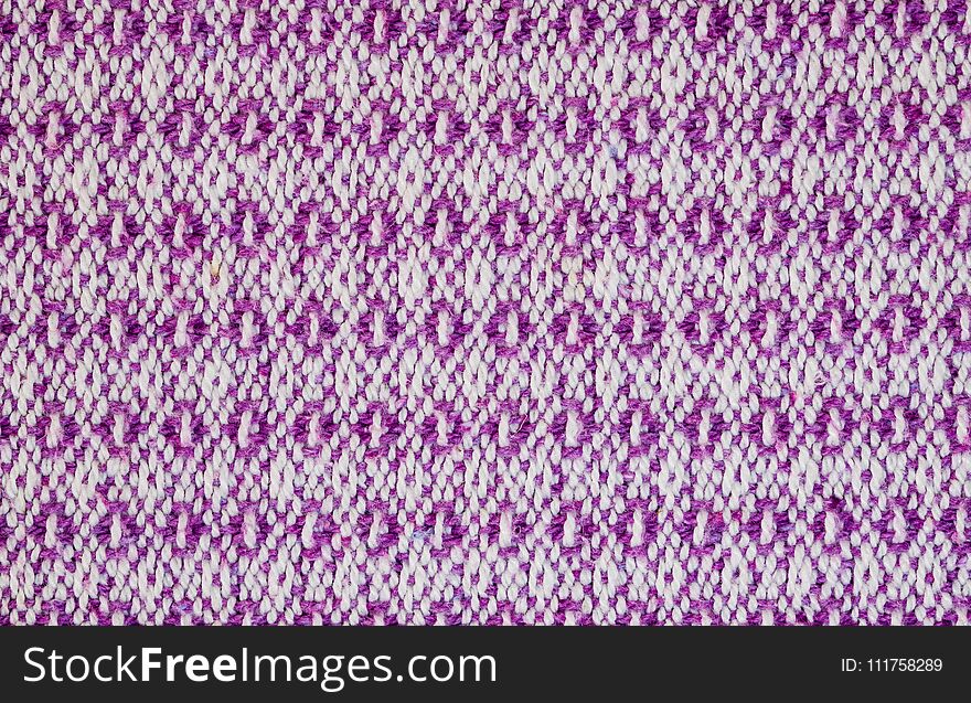 Texture of the fabric surface made of knitted natural cotton fiber, purple-lilac pattern, abstract background. Texture of the fabric surface made of knitted natural cotton fiber, purple-lilac pattern, abstract background