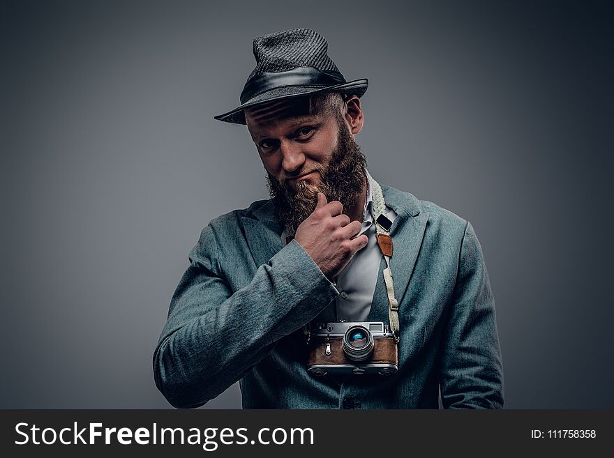 A Man Dressed In A Grey Jacket And Felt Hat Holds An SLR Photo C