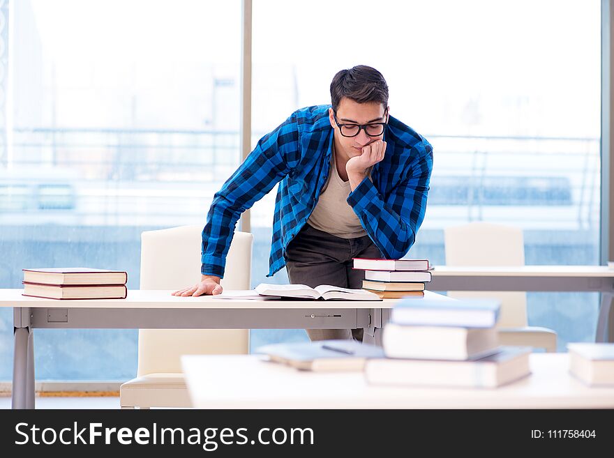 Student studying in the empty library with book preparing for ex