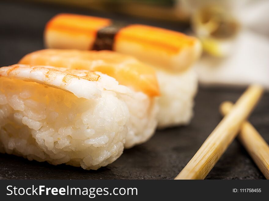 Traditional japanese sushi nigiri and chopstickson stone desk. Traditional japanese sushi nigiri and chopstickson stone desk