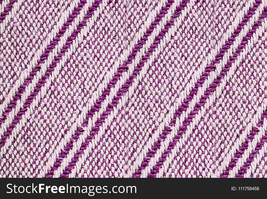 Texture of the fabric surface made of knitted natural cotton fiber, purple-lilac pattern, abstract background. Texture of the fabric surface made of knitted natural cotton fiber, purple-lilac pattern, abstract background