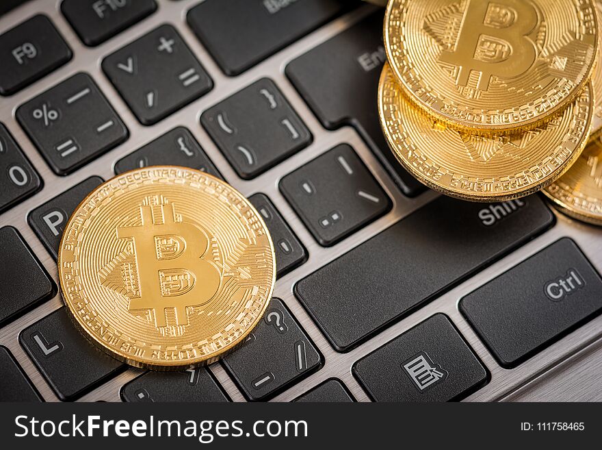 Gold coins crypto currency bitcoin and keyboard