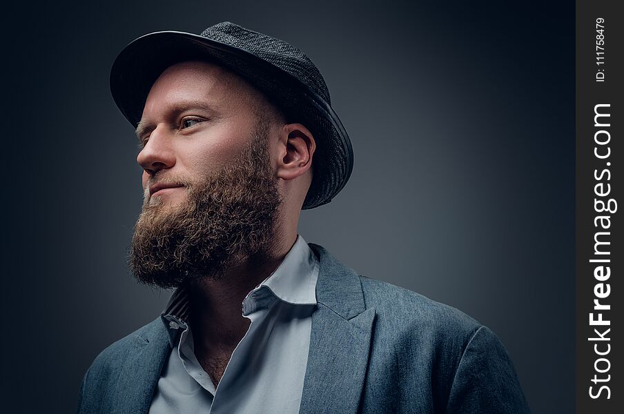 Close up studio portrait of bearded male in a felt hat on grey background. Close up studio portrait of bearded male in a felt hat on grey background.