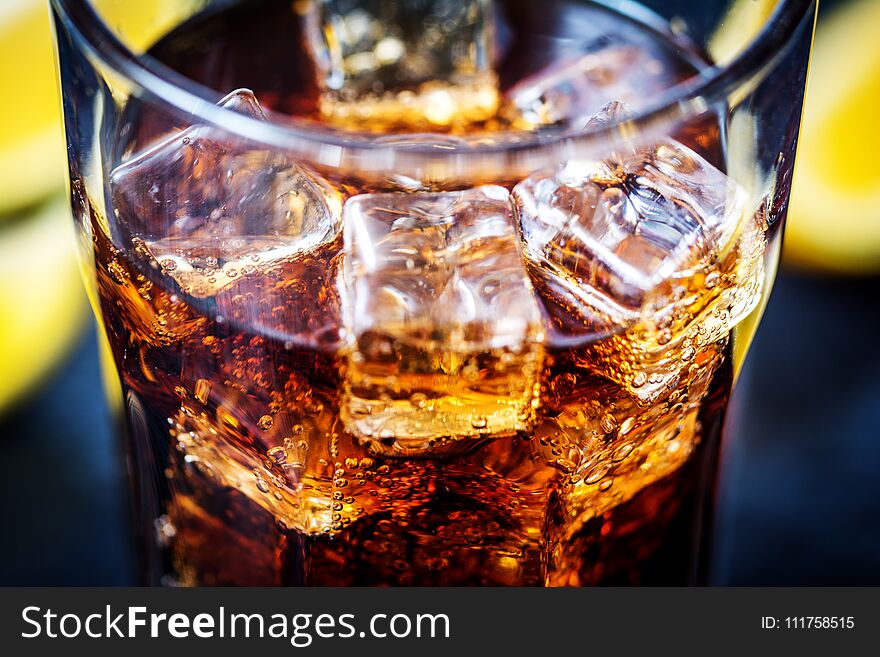 Cold cola drink with bubbles and ice cubes. Cold cola drink with bubbles and ice cubes