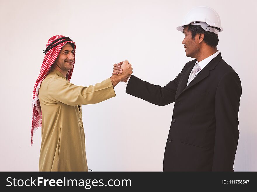 Arab businessman and foreman worker handshaking, USA