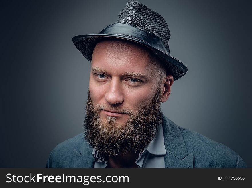 Close up portrait of bearded male in a felt hat.