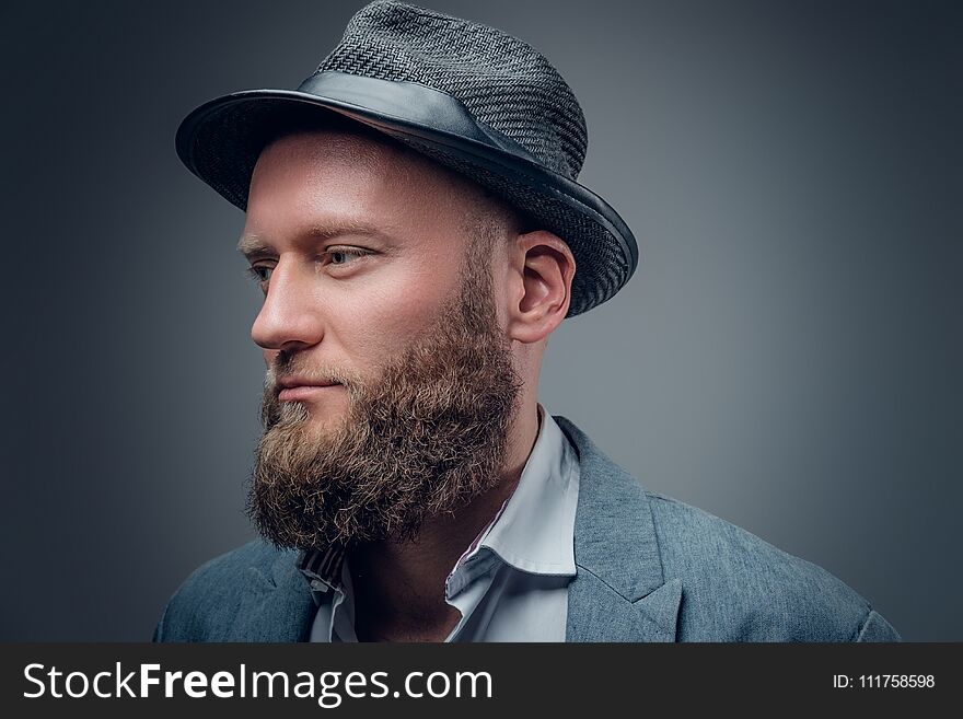 Close up portrait of bearded male in a felt hat.