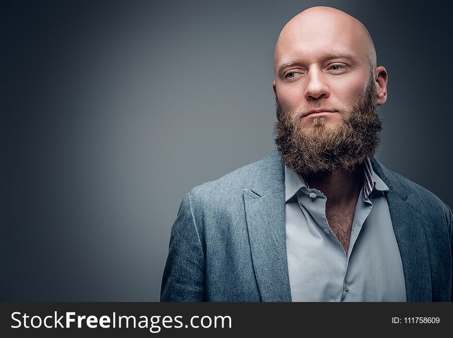 Hairless male in a suit on grey vignette background.