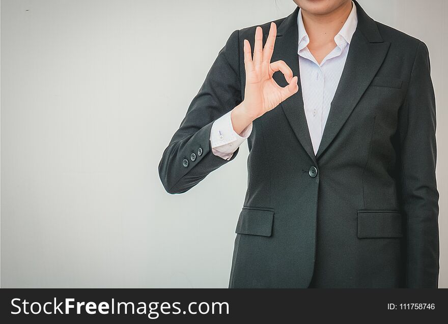 Businesswoman pointing up ok hand sign