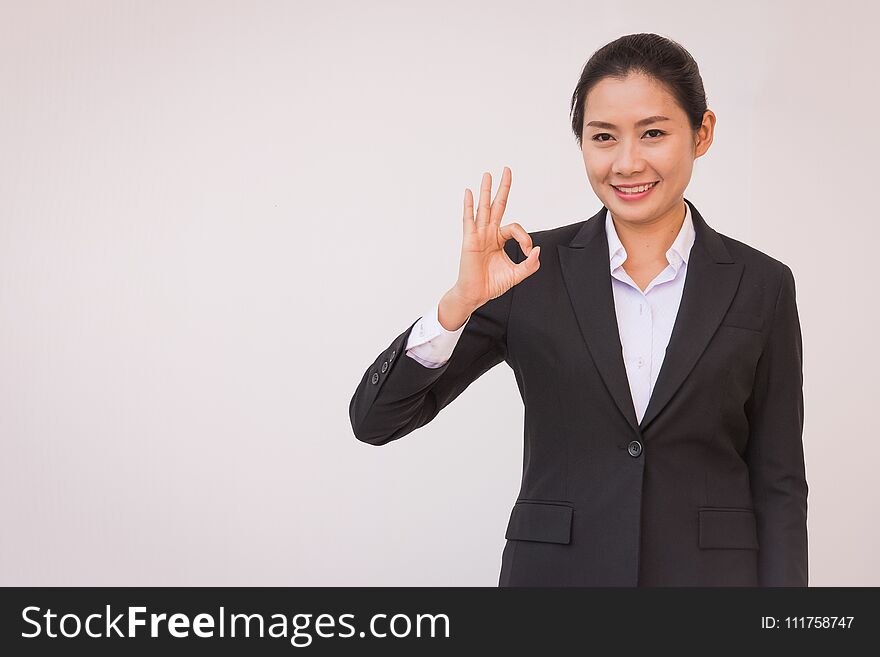 Businesswoman pointing up ok hand sign