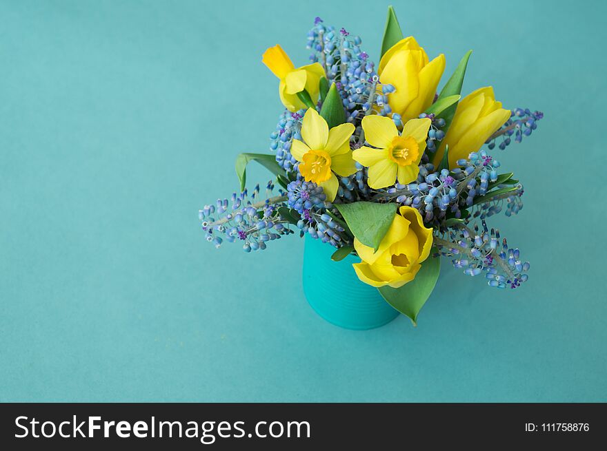 Bouquet of daffodils, tulips and Muscari.Easter. Easter eggs are blue and turquoise.