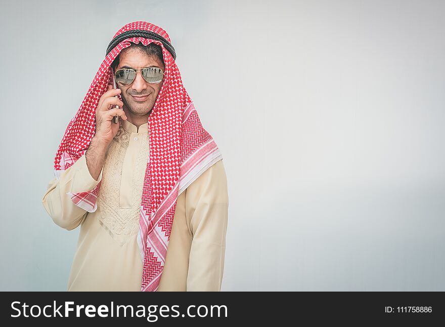 Arab businessman useing on a mobile phone.