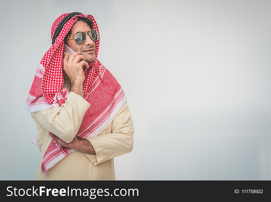 Arab businessman useing on a mobile phone, man