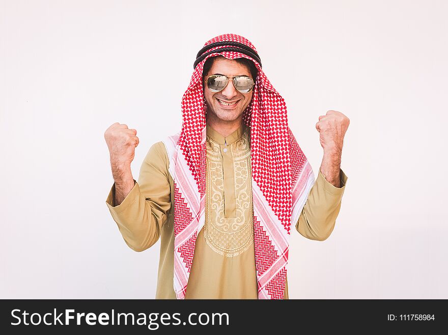 Happy young Arab businessman with hands up.