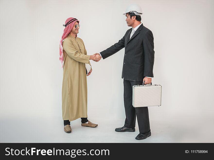 Arab businessman and foreman worker handshaking, man