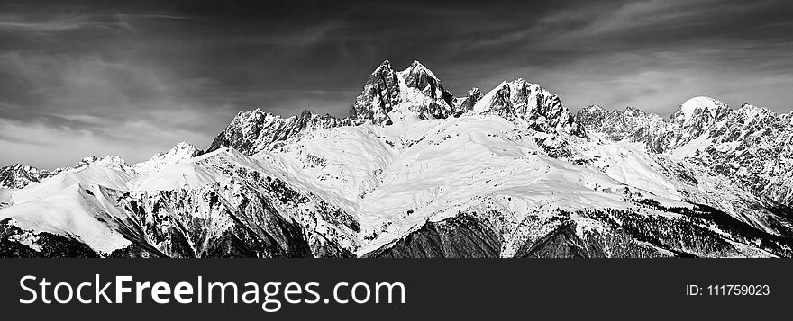 Black and white panoramic view on Mount Ushba at wind sunny day. Caucasus Mountains. Svaneti region of Georgia.
