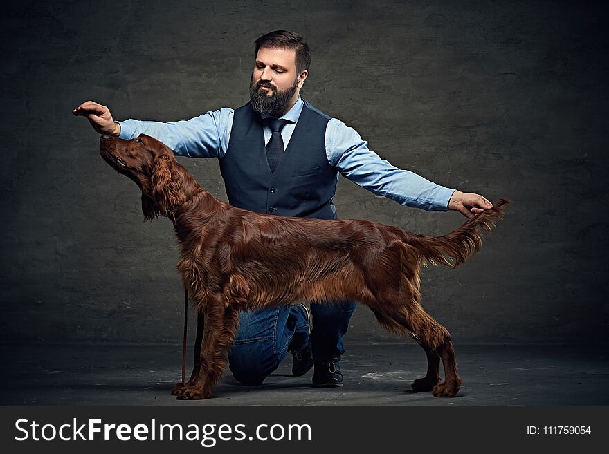 Stylish bearded middle age male and his mammals friend Irish red setter. Stylish bearded middle age male and his mammals friend Irish red setter.