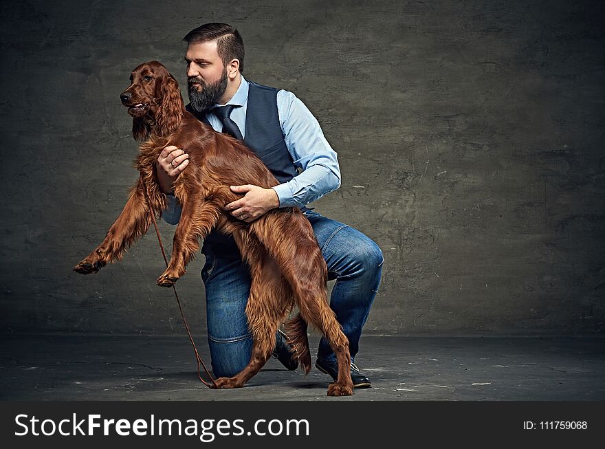 Stylish bearded middle age male and his mammals friend Irish red setter. Stylish bearded middle age male and his mammals friend Irish red setter.