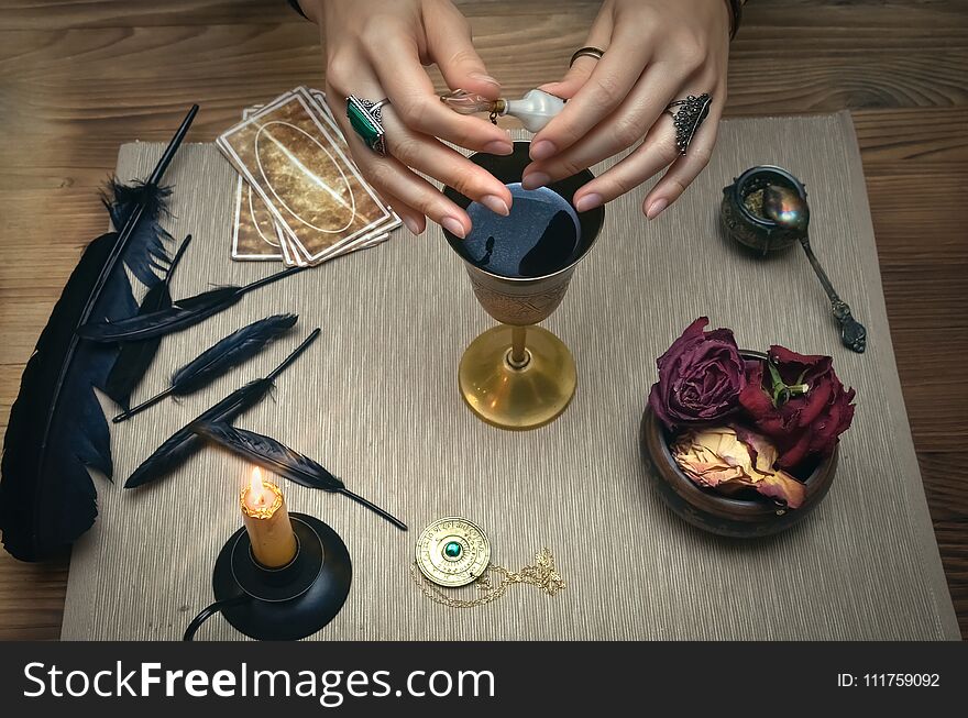 Woman witch prepare a magic potion. Tarot cards. Future reading. Fortune teller concept.