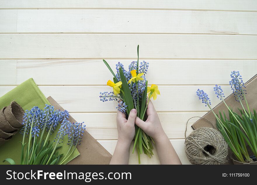 Children`s hands collect a bouquet as a gift. A gift for mom.