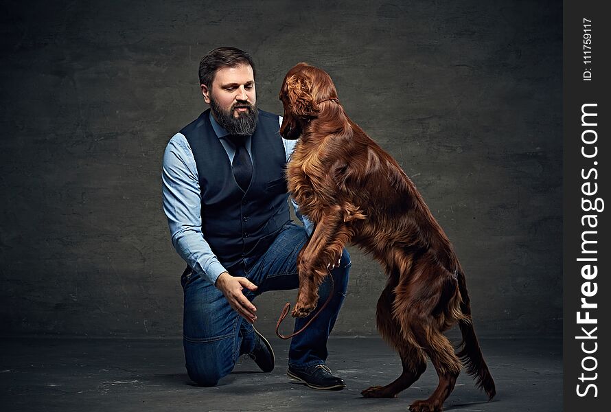 Stylish bearded middle age male and his mammals friend Irish red setter. Stylish bearded middle age male and his mammals friend Irish red setter.