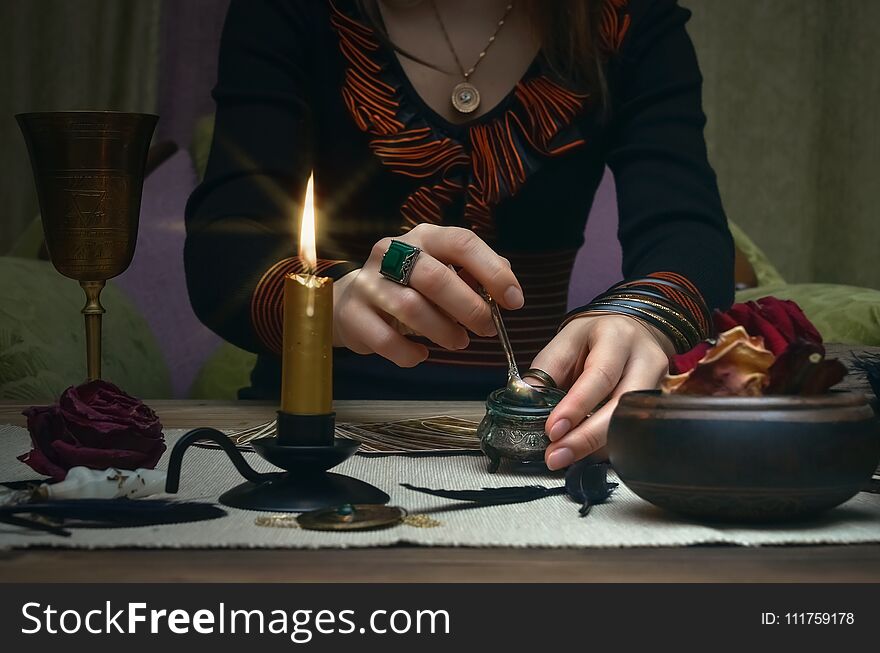 Woman witch prepare a magic potion. Future reading. Tarot cards on fortune teller desk table. Woman witch prepare a magic potion. Future reading. Tarot cards on fortune teller desk table.