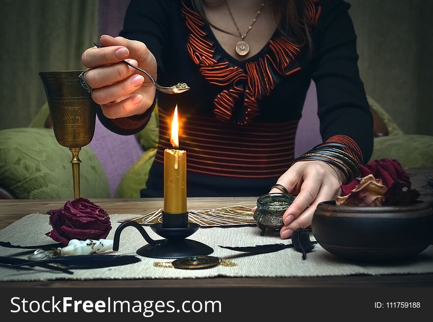 Woman witch prepare a magic potion. Future reading. Tarot cards on fortune teller desk table. Woman witch prepare a magic potion. Future reading. Tarot cards on fortune teller desk table.