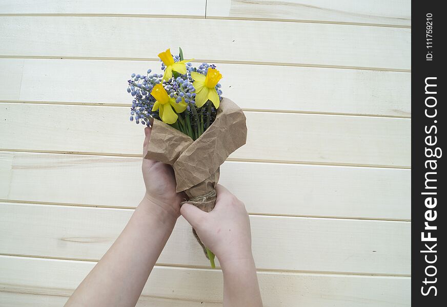 Children`s hands collect a bouquet as a gift. A gift for mom.